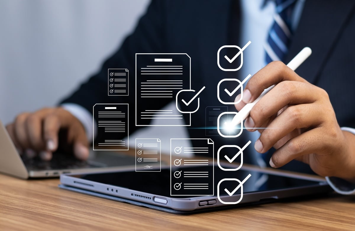 A businessman checking boxes with form symbols