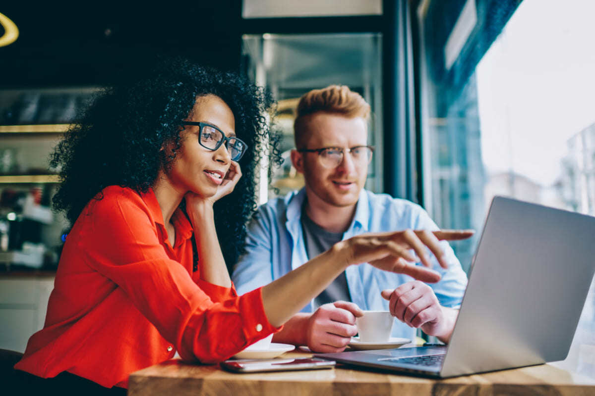 Two business professionals looking at a laptop