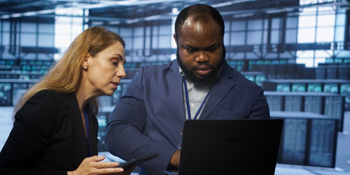 Two people looking at a laptop